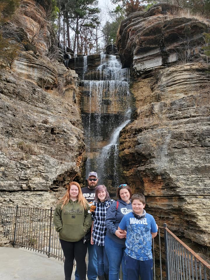 family in front of a waterfall