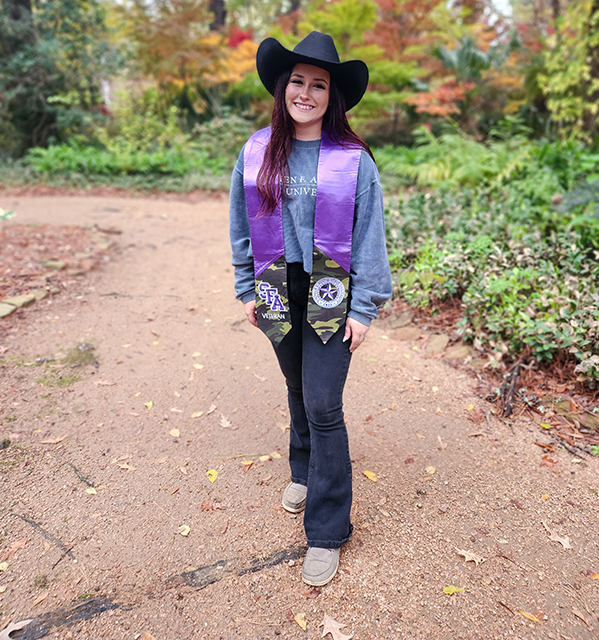 girl in cowboy hat on dirt road